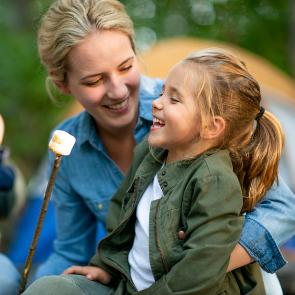 Mother & daughter enjoying toasted marshmallow after her pediatric dental care in Pflugerville, TX.