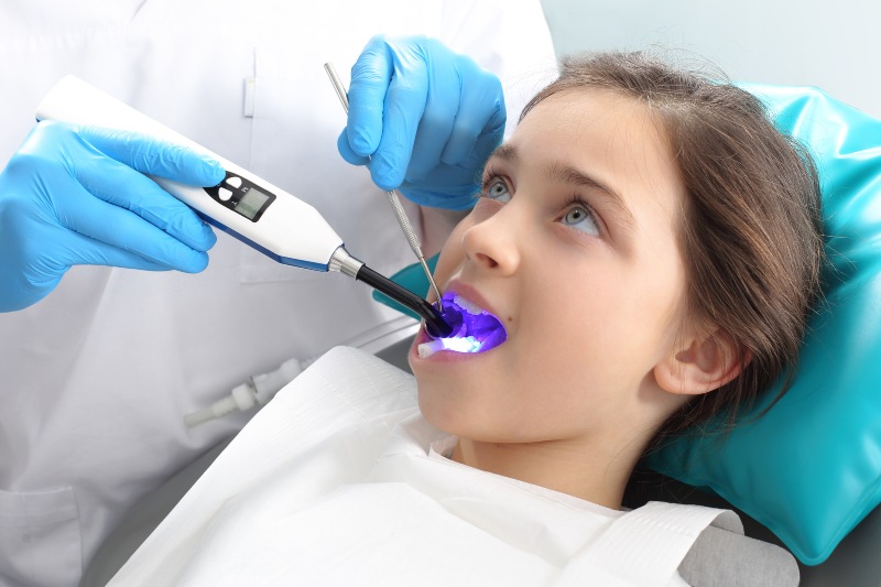 A girl getting dental sealants to protect teeth from dental cavities in Pflugerville, TX.